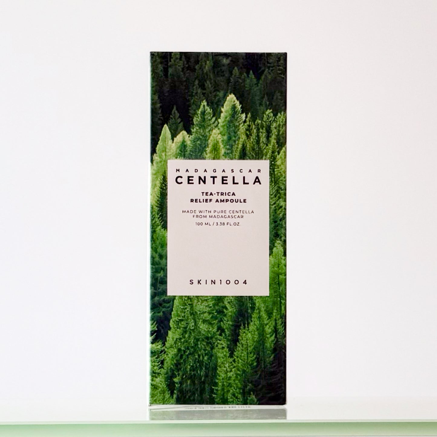 Product packaging with a forest design and visible branding on a white background